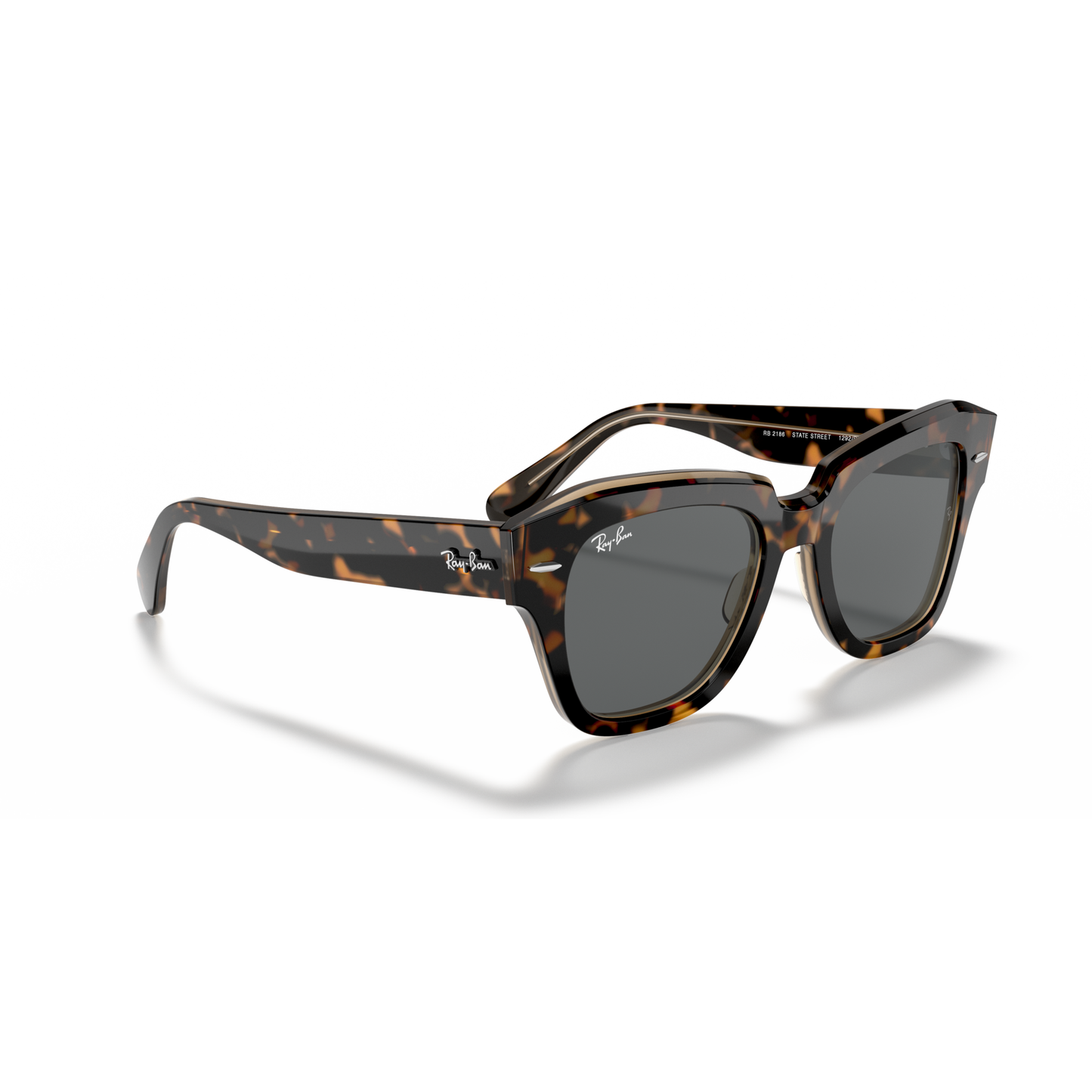 Sunglasses with tortoiseshell frame and dark lenses on a white background Polished Havana on Transparent Brown + Dark Grey
