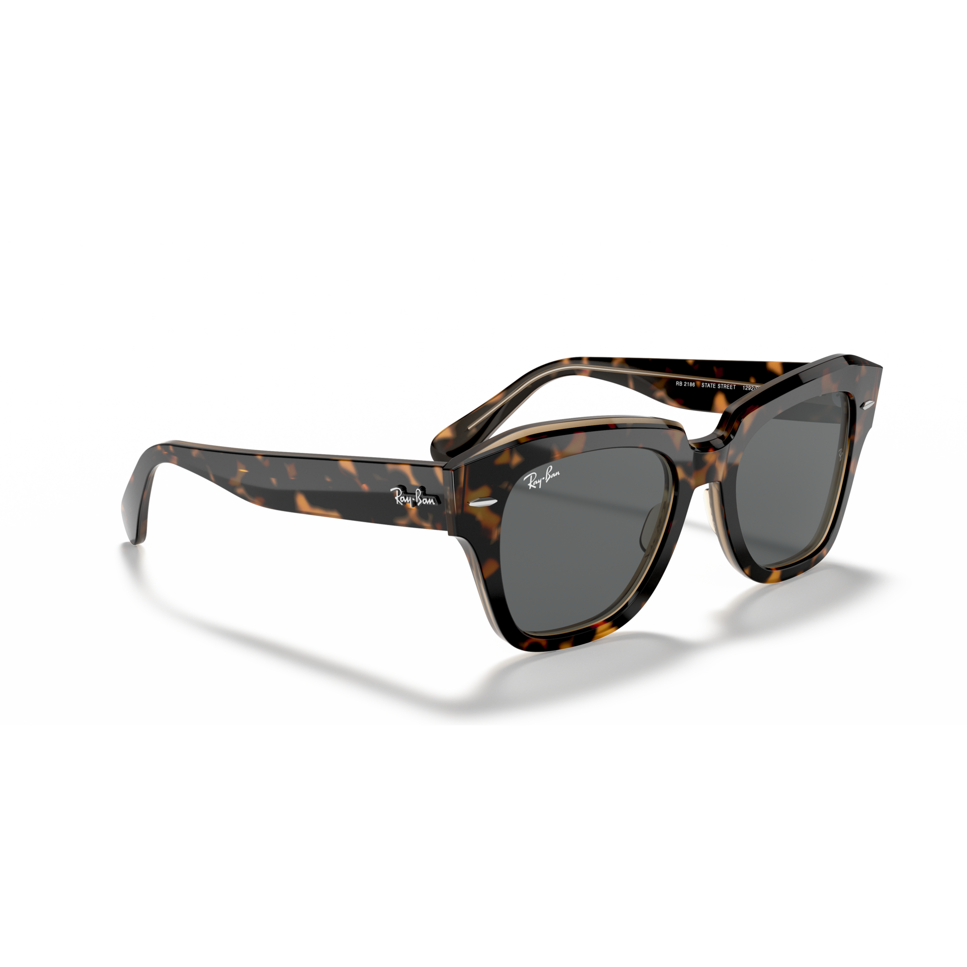 Sunglasses with tortoiseshell frame and dark lenses on a white background Polished Havana on Transparent Brown + Dark Grey