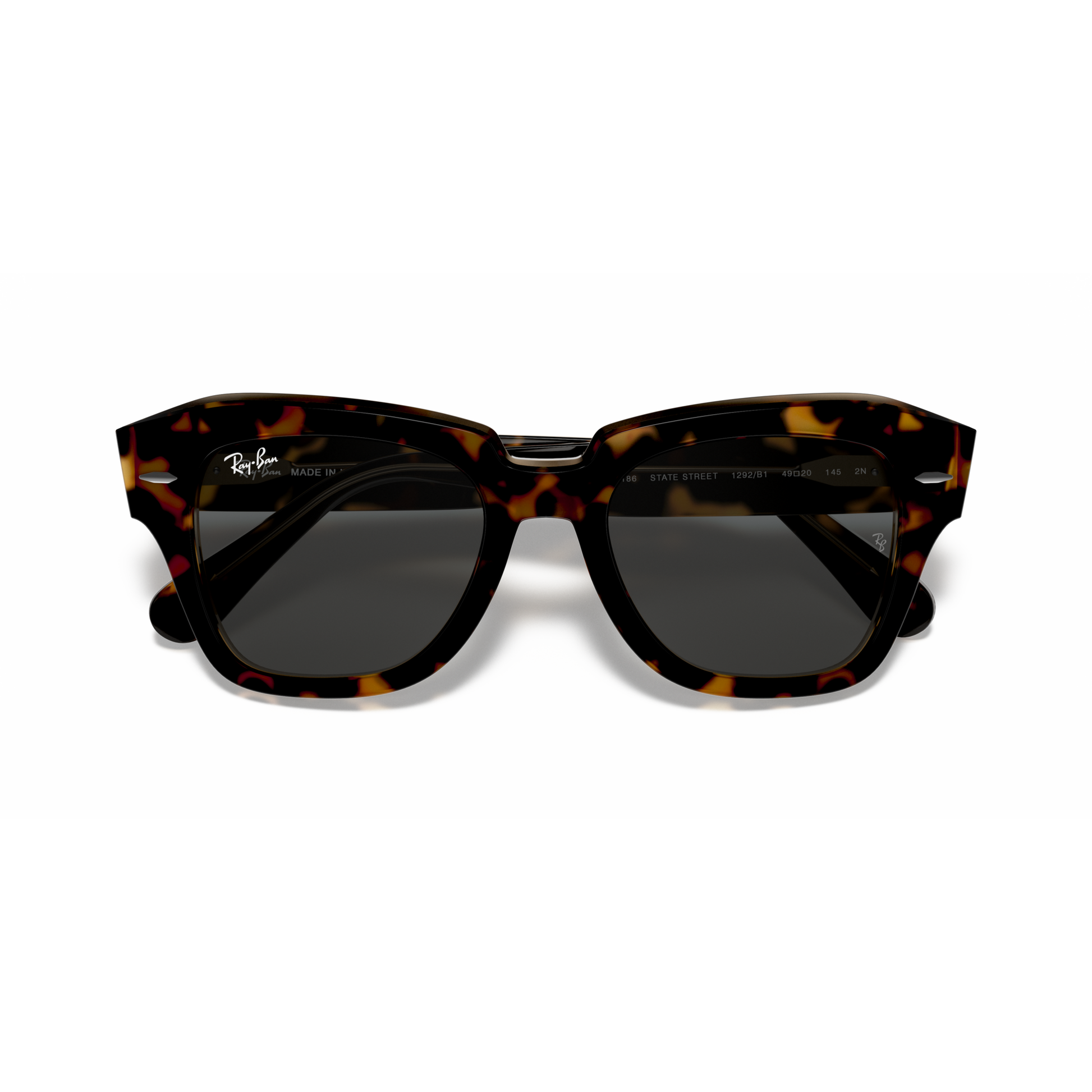 Tortoiseshell sunglasses with dark lenses on a white background Polished Havana on Transparent Brown + Dark Grey