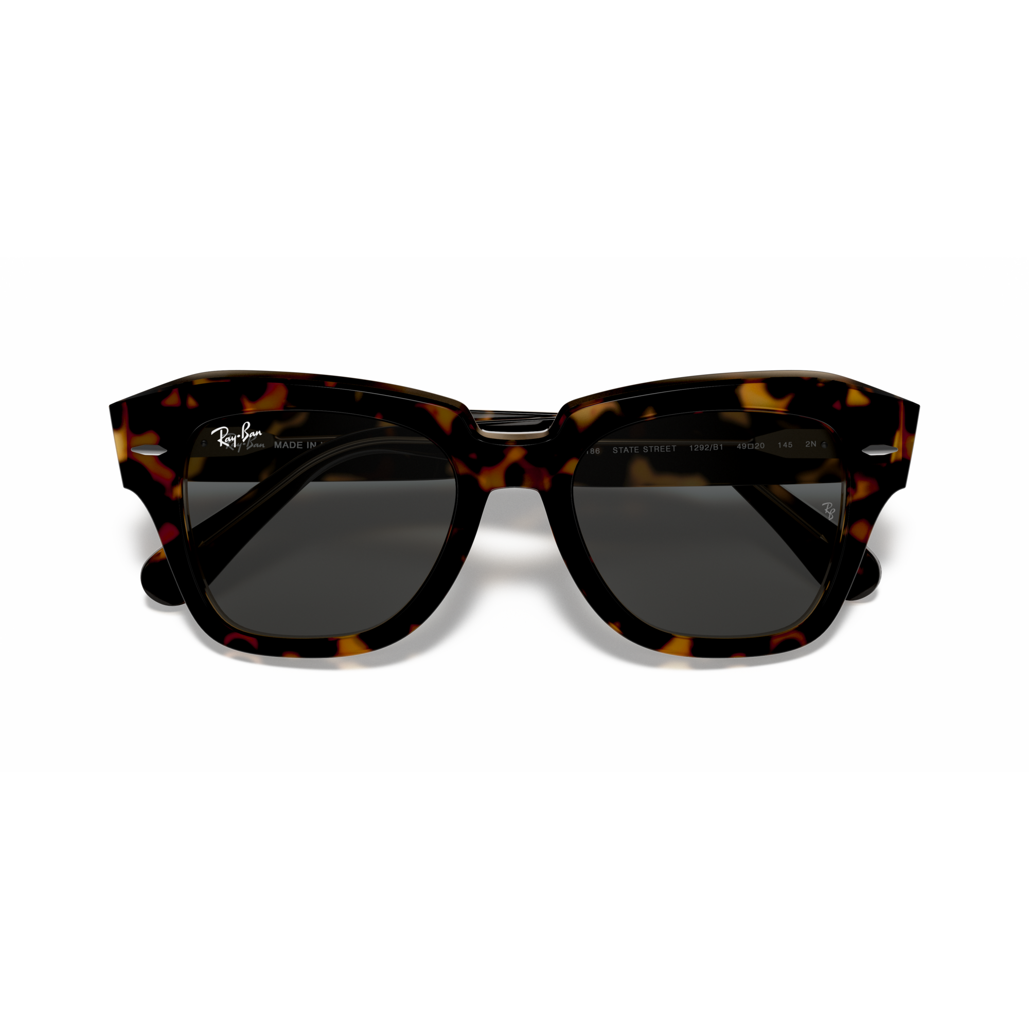 Tortoiseshell sunglasses with dark lenses on a white background Polished Havana on Transparent Brown + Dark Grey