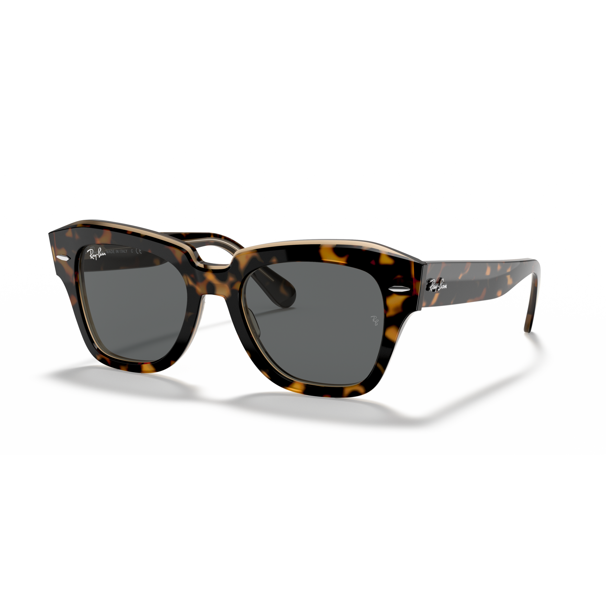 Tortoiseshell sunglasses with dark lenses on a white background Polished Havana on Transparent Brown + Dark Grey