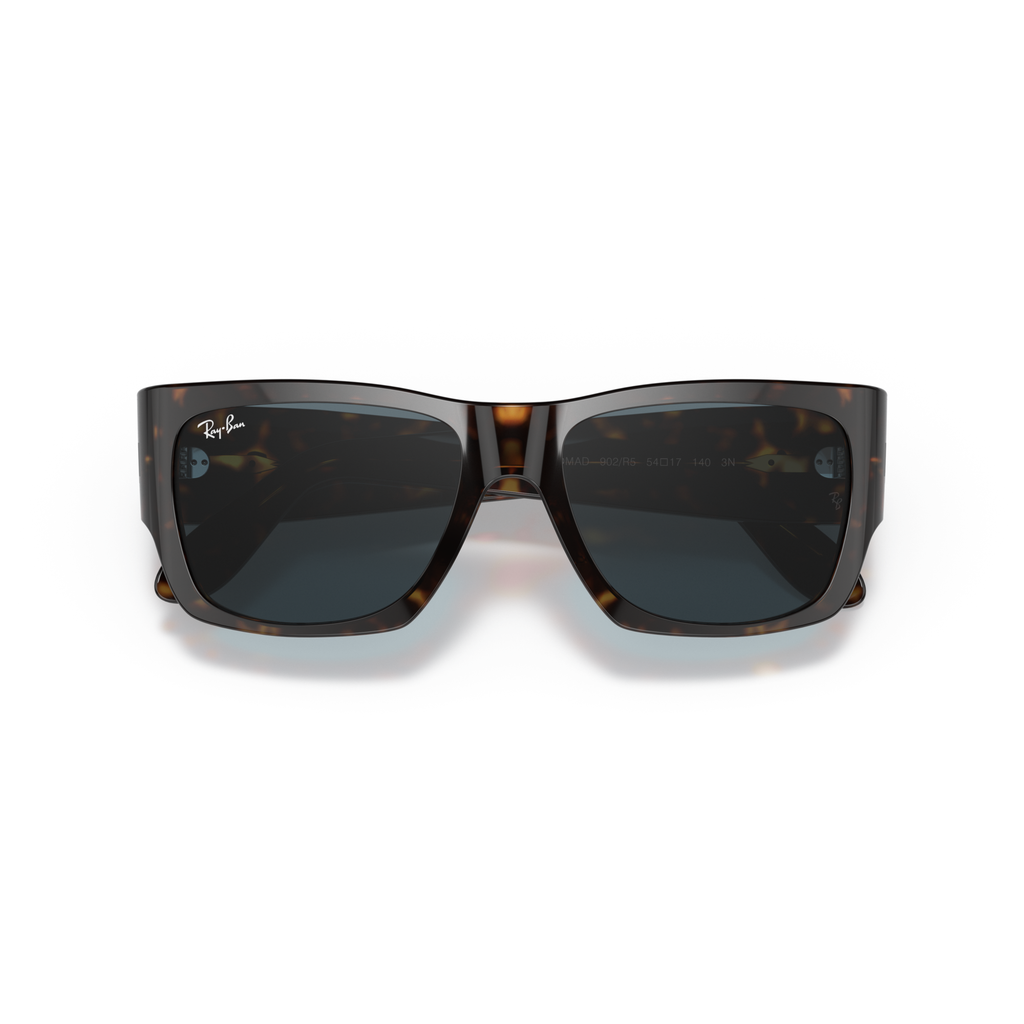 Sunglasses with tortoiseshell frame and dark lenses on a white background Polished Tortoise + Blue