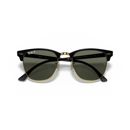 Black and gold sunglasses with dark lenses on a white background Polished Black on Gold + G-15 Polarised