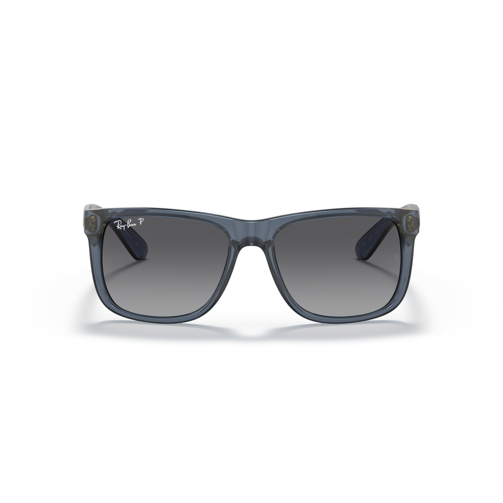 Sunglasses with a blue frame and dark lenses on a white background Polished Transparent Blue + Gradient Grey Polarised