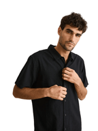 Man wearing a black shirt against a plain background