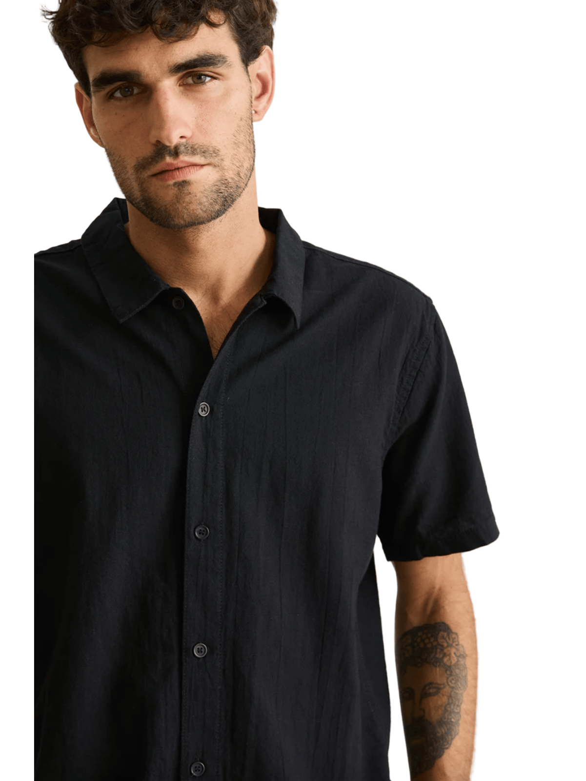 Man wearing a black shirt against a beige background