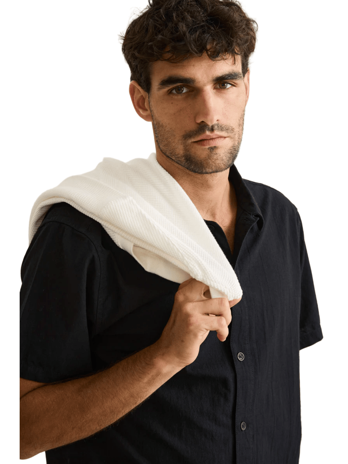 Man holding a white towel over his shoulder against a plain background