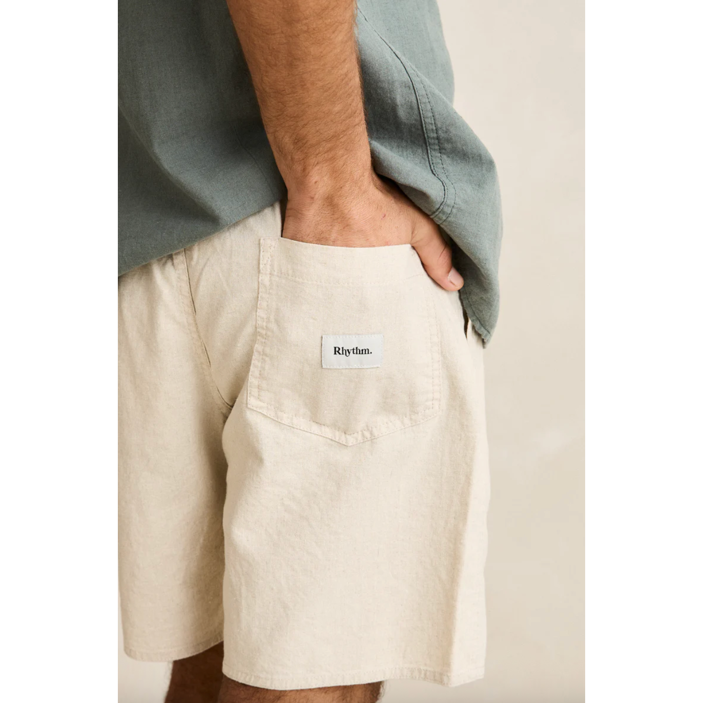 Beige shorts with a visible brand label on a neutral background