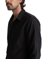 Man wearing a black shirt against a white background