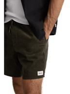Person wearing black shorts with a visible brand logo on a white background