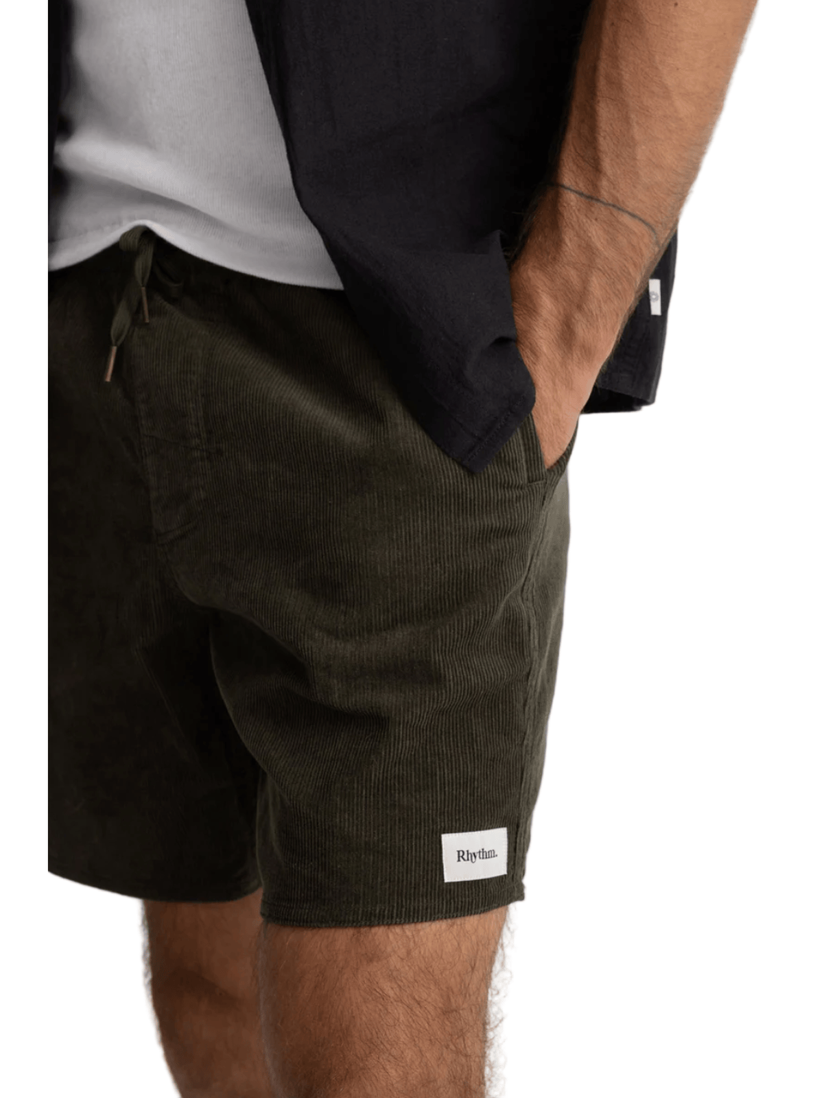 Person wearing black shorts with a visible brand logo on a white background