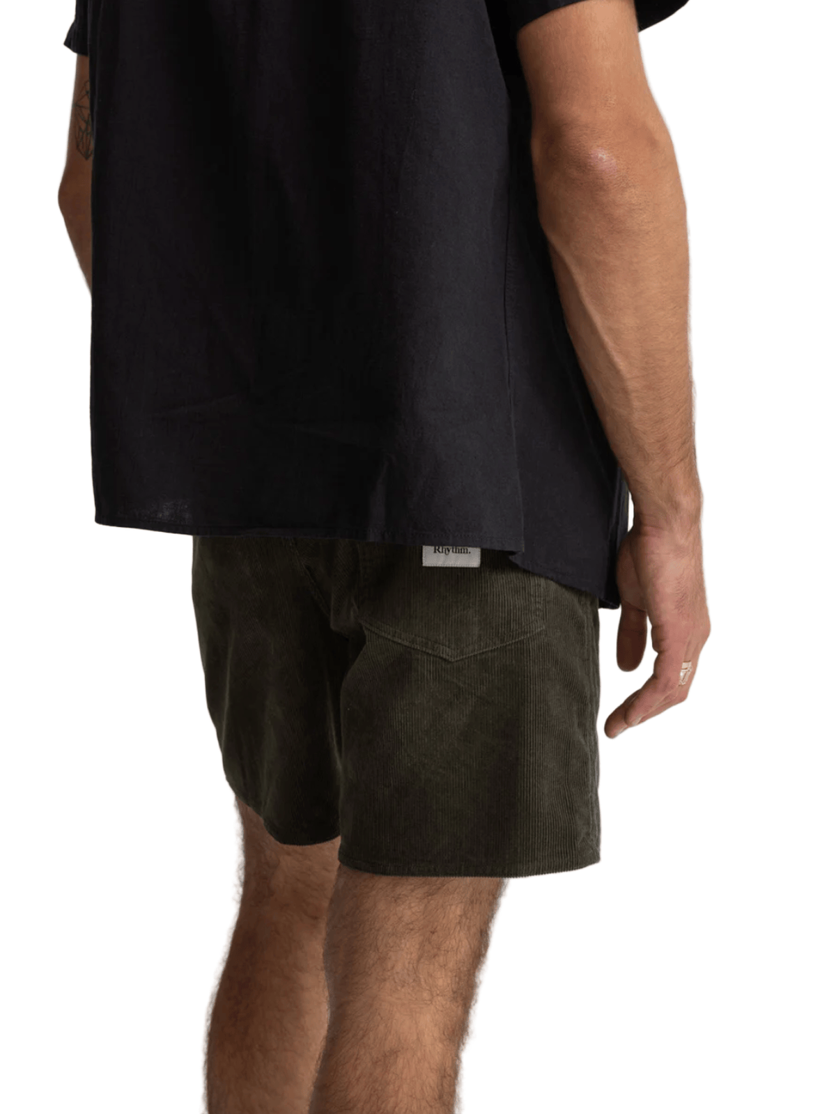 Person wearing black shirt and green shorts on a white background